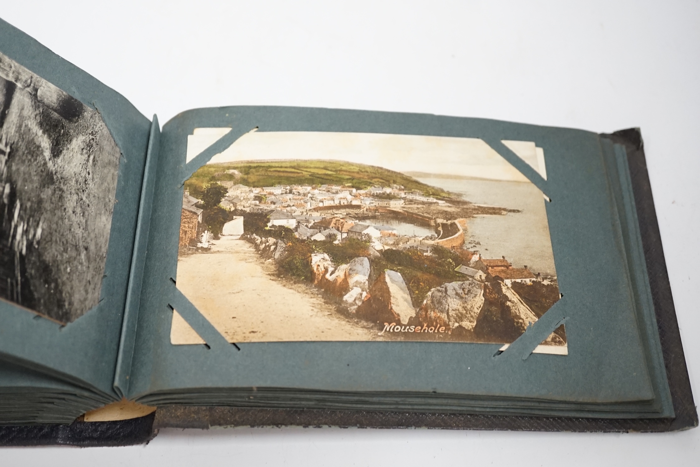 Three postcard albums, topographical examples including the Isle of Wight